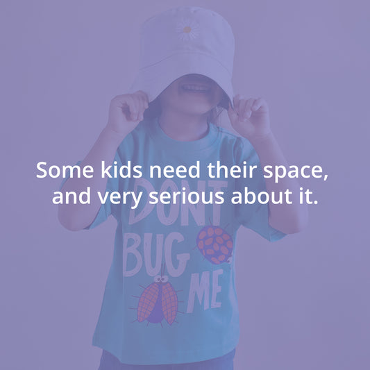 Kid wearing a cap and t-shirt with text, against a purple background