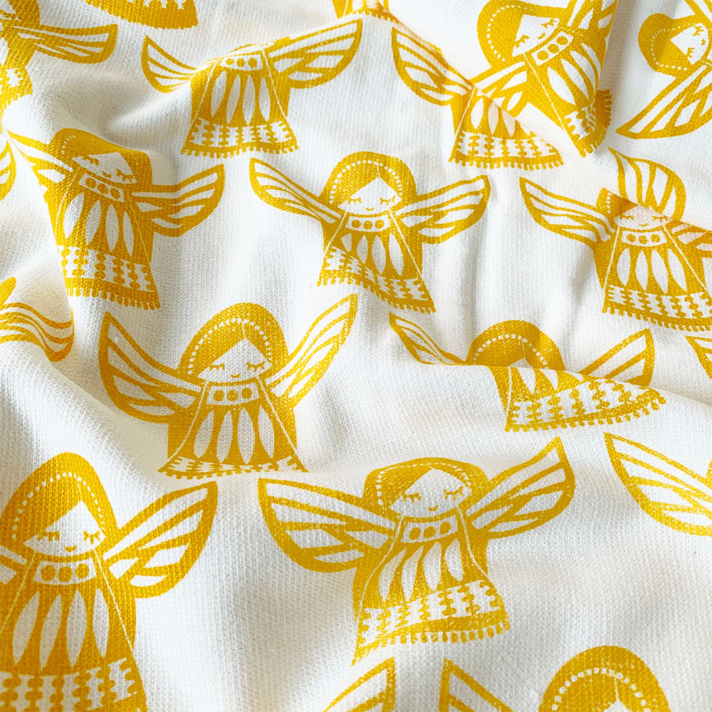 Close-up of Angel-inspired print on Mapayah WRAP Angela Yellow kids bath towel