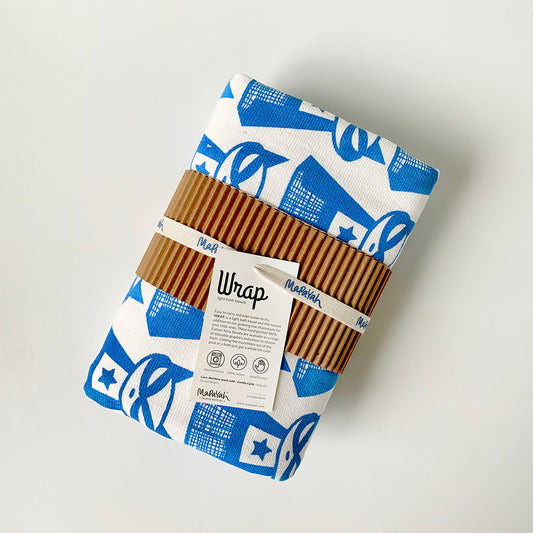 Mapayah superhero blue towel with a label and neatly put into a sleeve. looks organic perfect for gifting