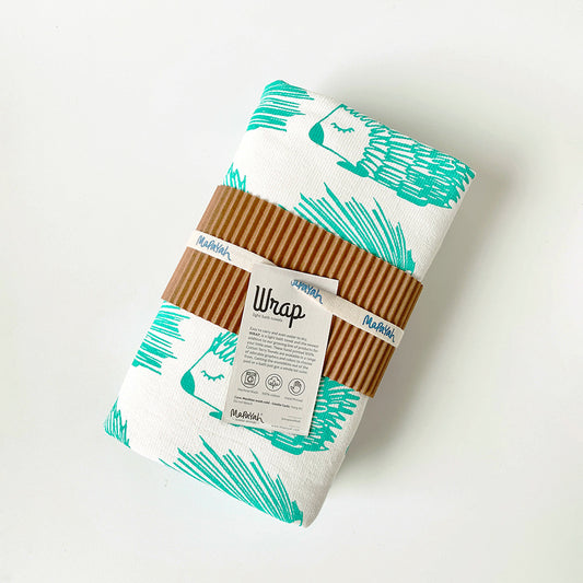 Mapayah green cotton bath towel with porcupine print, neatly packed in a sleeve, showing its size and design.