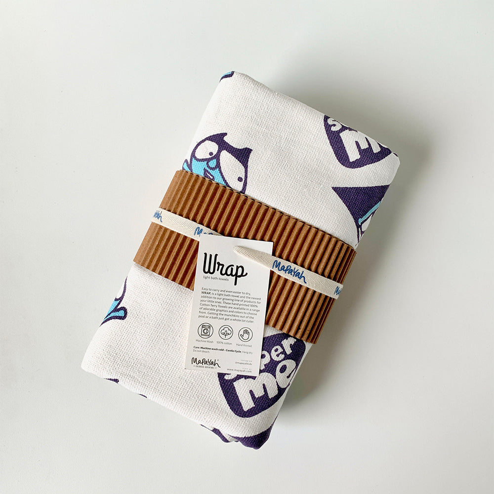 Mapayah green cotton bath towel with superhero print, neatly packed in a sleeve, showing its size and design.