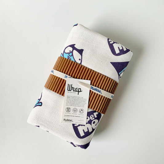 Mapayah green cotton bath towel with superhero print, neatly packed in a sleeve, showing its size and design.