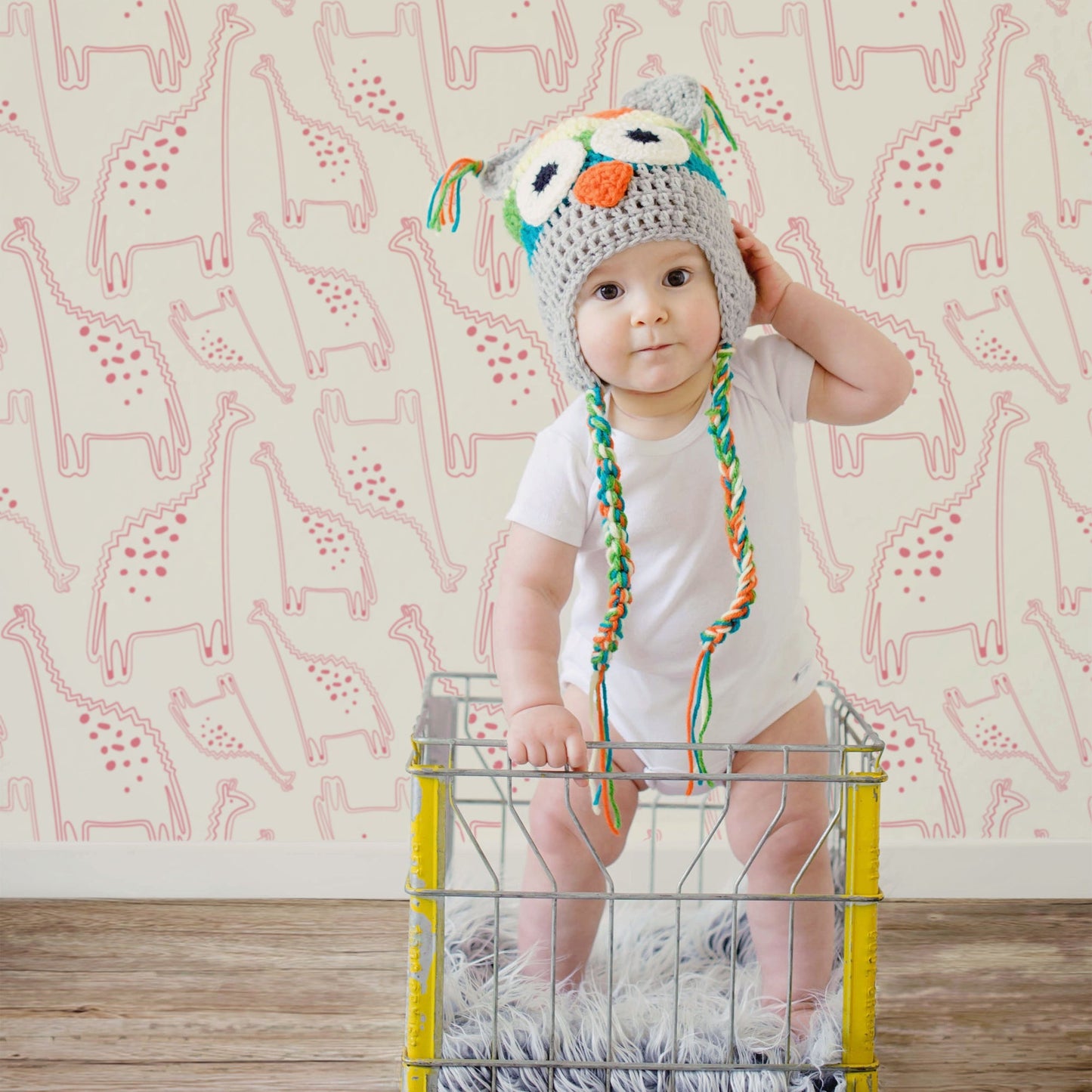 Mapayah DECK Dino kids room wallpaper in pink, styled in a bedroom setting