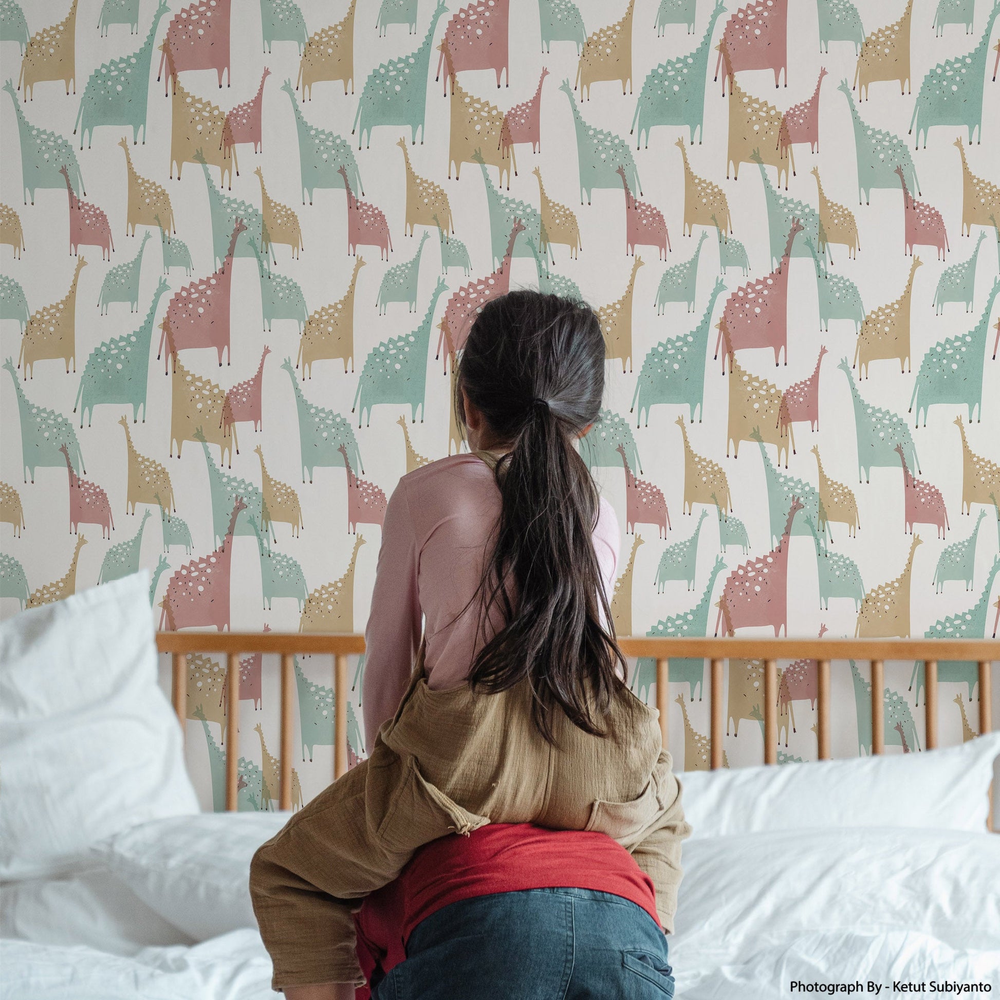 Mapayah DECK Jurassic kids room wallpaper in mild green, styled in a bedroom setting