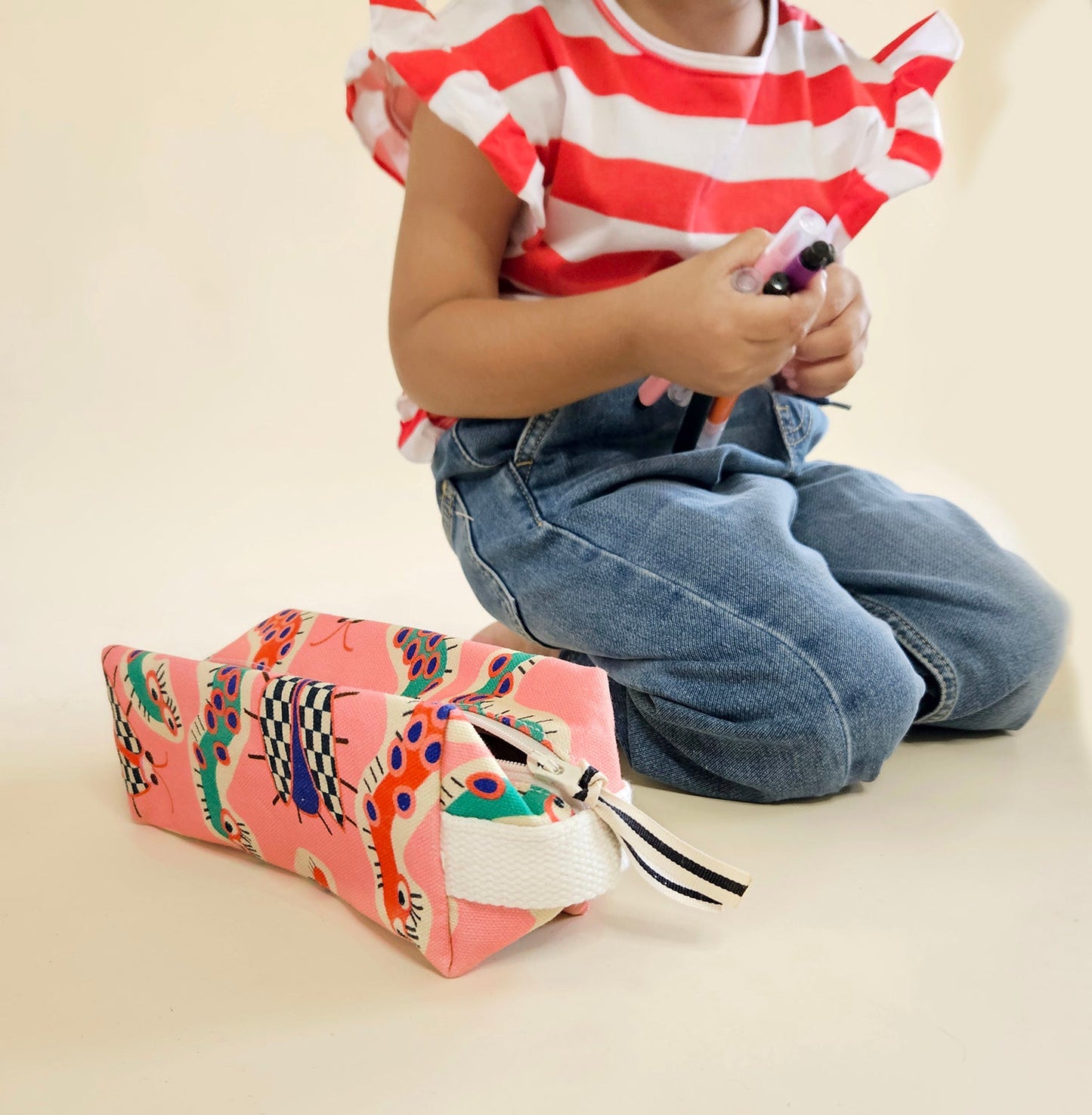 Mapayah POUCH Wiggle Pink kids pencil organizer styled in a lifestyle setting