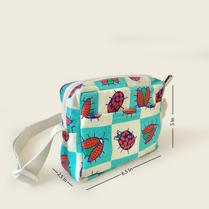A small fabric pouch with a white strap, featuring a turquoise and white checkered pattern with red ladybugs. The image includes dimension lines indicating measurements.