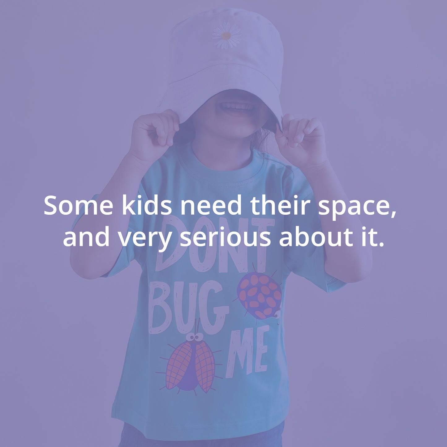 Kid wearing a cap and t-shirt with text, against a purple background